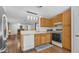 Open kitchen featuring wood cabinets, modern lighting, and stainless steel refrigerator at 8103 E Southern Ave # 222, Mesa, AZ 85209