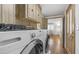 Convenient laundry room with modern appliances and overhead storage at 8103 E Southern Ave # 222, Mesa, AZ 85209