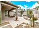 Beautiful backyard patio area featuring an outdoor fireplace, desert landscaping, and comfortable seating at 8220 E Mohawk Ln, Scottsdale, AZ 85255