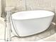 Modern freestanding soaking tub with chrome faucet and shower at 8220 E Mohawk Ln, Scottsdale, AZ 85255