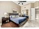 Bedroom with a blue bedspread, tile flooring, and a mirrored closet, perfect for relaxation and organization at 8220 E Mohawk Ln, Scottsdale, AZ 85255