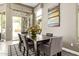 Elegant dining room with a dark wood table, comfortable chairs, and plenty of natural light at 8220 E Mohawk Ln, Scottsdale, AZ 85255