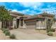 Beautiful single-story home featuring a three-car garage, desert landscaping and neutral stucco at 8220 E Mohawk Ln, Scottsdale, AZ 85255