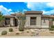 Charming single-story home with desert landscaping and a neutral color palette under a beautiful blue sky at 8220 E Mohawk Ln, Scottsdale, AZ 85255