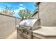 Built-in stainless steel BBQ grill in a desert landscaped yard at 8220 E Mohawk Ln, Scottsdale, AZ 85255