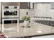 Modern kitchen island with granite countertop and stainless steel oven appliances at 8220 E Mohawk Ln, Scottsdale, AZ 85255