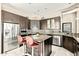 Modern kitchen with stainless steel appliances, a center island, and dark wood cabinetry at 8220 E Mohawk Ln, Scottsdale, AZ 85255
