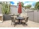 Covered outdoor dining table and chairs in a desert landscape at 8220 E Mohawk Ln, Scottsdale, AZ 85255