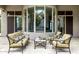 Covered patio with elegant outdoor furniture facing a large bay window, creating a relaxing outdoor retreat at 8220 E Mohawk Ln, Scottsdale, AZ 85255