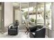 Cozy sitting area with comfortable chairs and views of the landscaped backyard at 8220 E Mohawk Ln, Scottsdale, AZ 85255