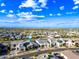 Neighborhood aerial view showcases the home and surrounding landscape with blue skies and scattered clouds at 830 E Buist Ave, Phoenix, AZ 85042