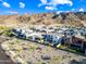 Expansive aerial shot of a community, highlighting modern homes with pools and picturesque mountain views at 830 E Buist Ave, Phoenix, AZ 85042