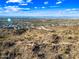 Aerial view of a desert community and mountain landscape under a blue, partly cloudy sky at 830 E Buist Ave, Phoenix, AZ 85042