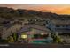 Aerial view of backyard with pool, patio, and mountain views at sunset at 830 E Buist Ave, Phoenix, AZ 85042