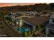 Aerial view of fenced backyard with a pool, patio furniture, and mountain views at sunset at 830 E Buist Ave, Phoenix, AZ 85042