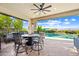 Resort-style backyard with a covered patio, outdoor kitchen, lush greenery, and a refreshing pool at 830 E Buist Ave, Phoenix, AZ 85042