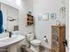Charming half bath with a pedestal sink, decorative accents, and a coastal theme at 830 E Buist Ave, Phoenix, AZ 85042