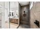 Sleek bathroom featuring a glass-enclosed shower with a built-in bench, and modern fixtures at 830 E Buist Ave, Phoenix, AZ 85042