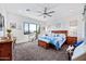 Spacious bedroom with a ceiling fan, ample lighting, and a large window showcasing outdoor views at 830 E Buist Ave, Phoenix, AZ 85042