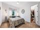 Cozy bedroom features neutral tones, a patterned bedspread, and an organized walk-in closet at 830 E Buist Ave, Phoenix, AZ 85042