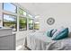 Bright bedroom with large windows offering scenic views and a stylish decorative wall piece at 830 E Buist Ave, Phoenix, AZ 85042
