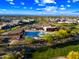 Resort-style community pool and clubhouse surrounded by lush landscaping and homes, with mountain views in the background at 830 E Buist Ave, Phoenix, AZ 85042