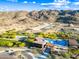 Scenic aerial view of community pool, clubhouse, desert landscaping, and mountain vistas, blending recreation with nature at 830 E Buist Ave, Phoenix, AZ 85042
