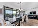 Bright dining room with a long table, decorative light fixture, and sliding glass doors to an outdoor patio with a view at 830 E Buist Ave, Phoenix, AZ 85042