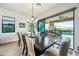 Elegant dining room with a large table, seating for ten, and access to the outdoor patio at 830 E Buist Ave, Phoenix, AZ 85042