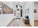 Bright entryway featuring tile floors, natural light, and walls decorated with Gathering photos at 830 E Buist Ave, Phoenix, AZ 85042