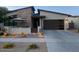 Striking single-story home boasting a contemporary design, stone facade, desert landscaping, and a cozy covered patio for relaxing at 830 E Buist Ave, Phoenix, AZ 85042