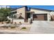 Beautiful single-story home featuring a modern elevation, stone accents, desert landscaping, and a covered patio for outdoor enjoyment at 830 E Buist Ave, Phoenix, AZ 85042