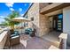 Charming front porch featuring outdoor seating and shade from a parasol at 830 E Buist Ave, Phoenix, AZ 85042