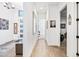 Bright hallway featuring neutral tile floors, white walls, and contemporary decor at 830 E Buist Ave, Phoenix, AZ 85042