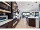 Modern kitchen with stainless steel appliances, granite countertops, and dark wood cabinets at 830 E Buist Ave, Phoenix, AZ 85042