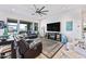 Comfortable living room with a ceiling fan, large windows, modern furniture, and a fireplace for cozy evenings at 830 E Buist Ave, Phoenix, AZ 85042