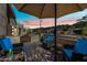 Relaxing outdoor seating area under an umbrella, offering scenic mountain views at sunset at 830 E Buist Ave, Phoenix, AZ 85042