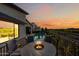 Beautiful evening view of a furnished patio with a fire pit and a refreshing pool at 830 E Buist Ave, Phoenix, AZ 85042