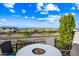 Scenic patio with a stylish fire pit table and comfortable seating overlooking the city and mountain views at 830 E Buist Ave, Phoenix, AZ 85042