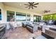 Inviting outdoor living area with ample seating, ceiling fans, and a view of the pool at 830 E Buist Ave, Phoenix, AZ 85042