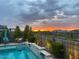 Peaceful pool area featuring comfortable seating, lush greenery, and a calming atmosphere, ideal for watching a vibrant sunset at 830 E Buist Ave, Phoenix, AZ 85042