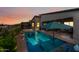 Backyard pool and covered patio area, ideal for evening relaxation and enjoying the colorful sunset views at 830 E Buist Ave, Phoenix, AZ 85042