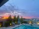 Tranquil pool area with cozy seating, lush plants, and a peaceful setting, creating a perfect spot to enjoy a colorful sunset at 830 E Buist Ave, Phoenix, AZ 85042
