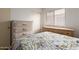 Bright bedroom with wooden furniture and natural light from a window at 8502 W Pierson St, Phoenix, AZ 85037
