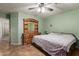 Bedroom with tile flooring, ceiling fan, dresser and ample space at 8502 W Pierson St, Phoenix, AZ 85037