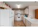Bright kitchen with white appliances, tile floors and plenty of storage space at 8502 W Pierson St, Phoenix, AZ 85037