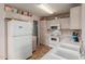 Bright kitchen with white appliances, tile floors and plenty of storage space at 8502 W Pierson St, Phoenix, AZ 85037