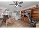 Open living room featuring tile floors, ceiling fan, and entertainment center at 8502 W Pierson St, Phoenix, AZ 85037