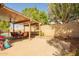 Backyard patio with outdoor seating with well manicured landscaping and desert flora at 9167 N 73Rd Ln, Peoria, AZ 85345