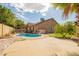 A refreshing backyard pool is the focal point, surrounded by a patio and lush green landscaping at 9167 N 73Rd Ln, Peoria, AZ 85345